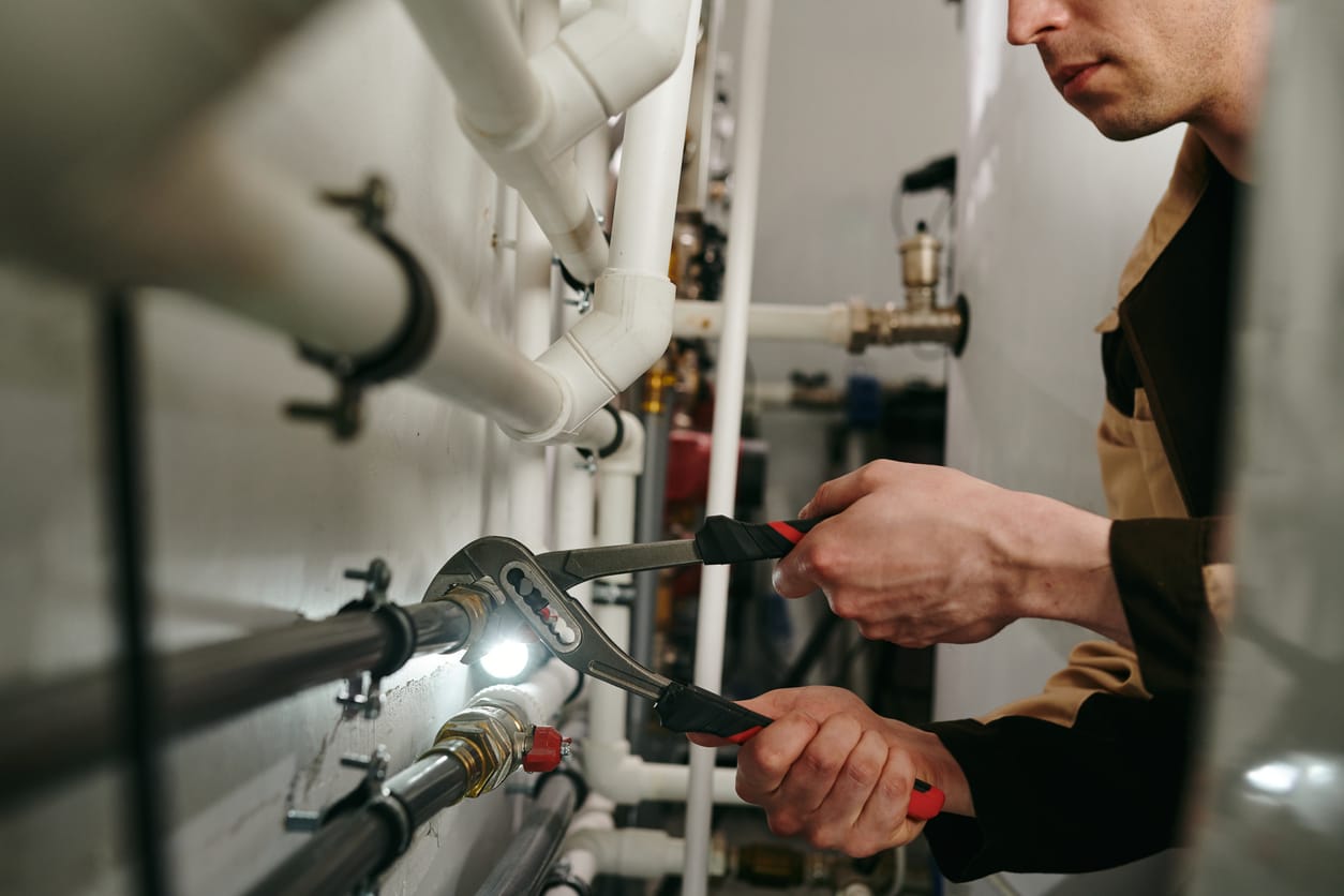 Plumbers maintaining commercial plumbing pipes in New Smyrna Beach