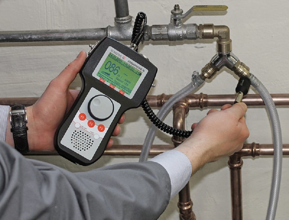 Plumber testing pipes with electronic leak detection equipment in New Smyrna Beach