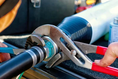 Technician tightening an industrial pipe connection in New Smyrna Beach
