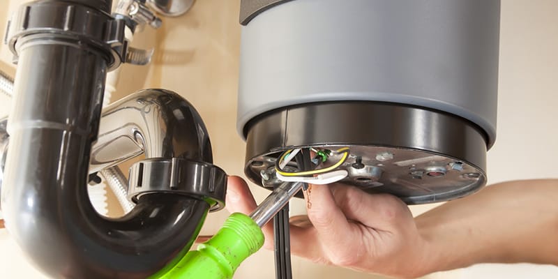 Technician repairing the heating element of a water heater in New Smyrna Beach