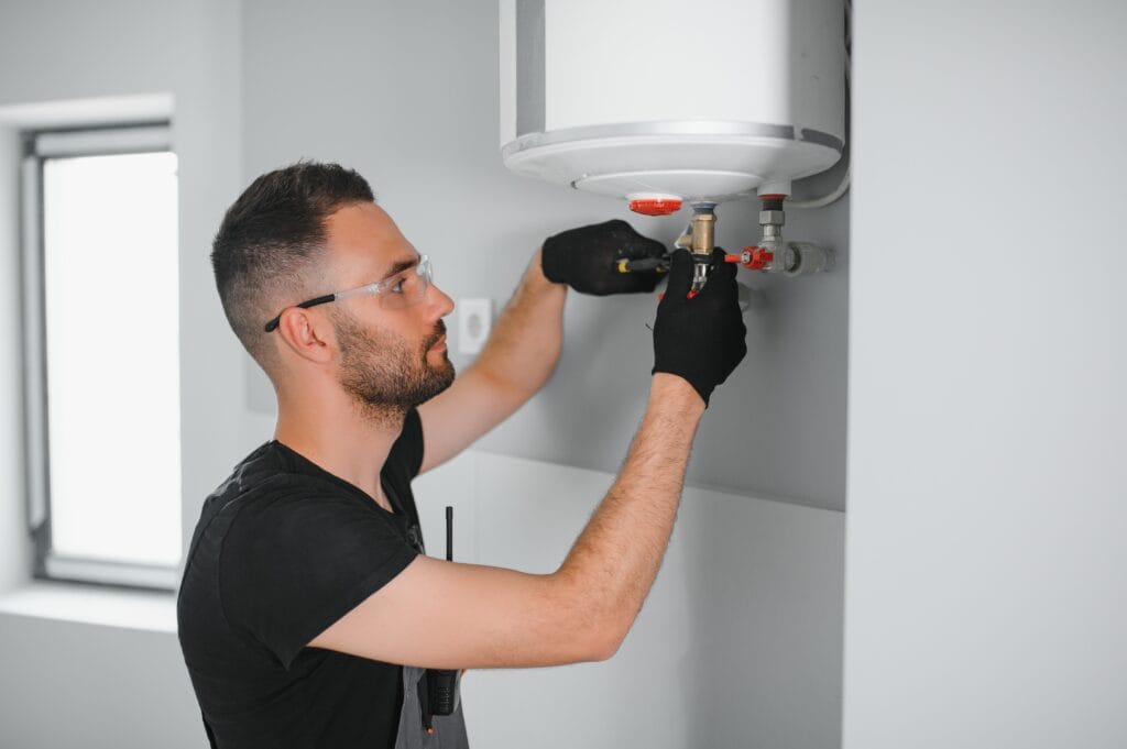 Technician performing water heater maintenance in New Smyrna Beach