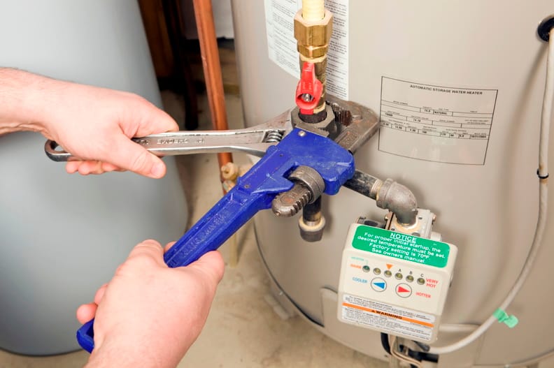 Plumber repairing a water heater valve in New Smyrna Beach